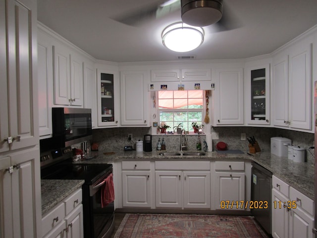 kitchen featuring backsplash, electric range, sink, black dishwasher, and white cabinets