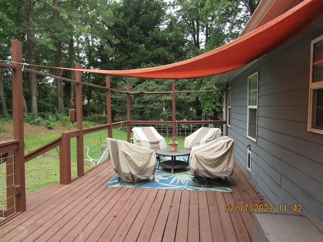 wooden deck featuring a yard and area for grilling