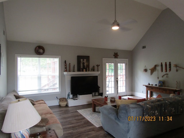 living room with plenty of natural light, ceiling fan, dark hardwood / wood-style floors, and french doors