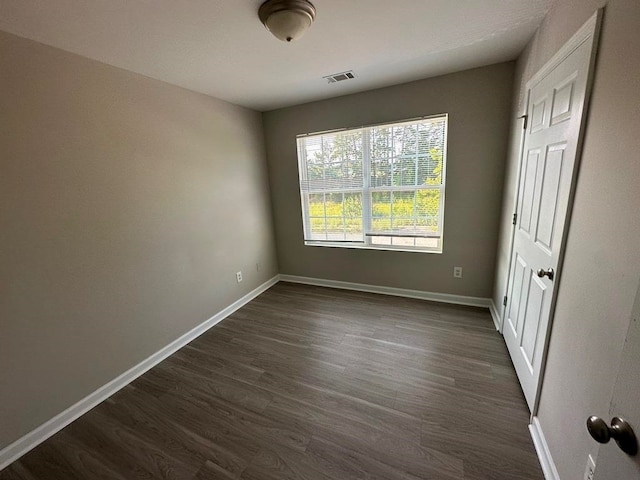 empty room with dark wood-type flooring