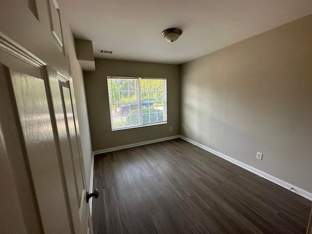 spare room featuring dark hardwood / wood-style flooring