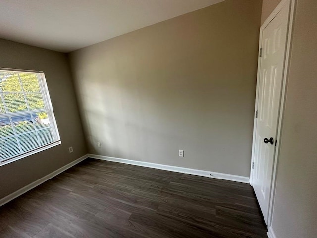 spare room with dark hardwood / wood-style floors