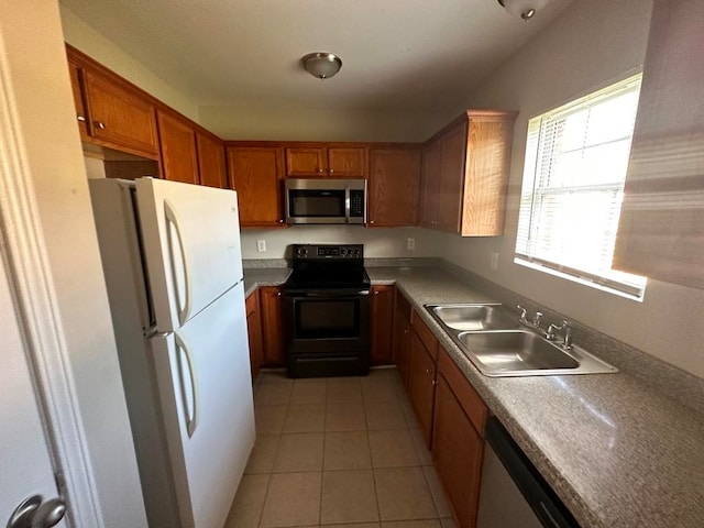 kitchen with stainless steel appliances, light tile floors, and sink