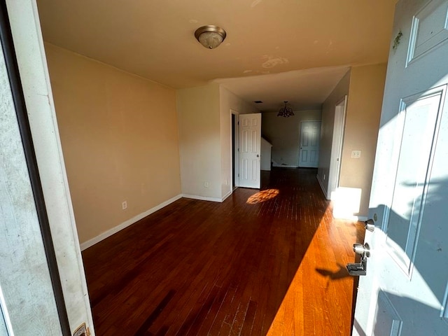 spare room with dark hardwood / wood-style floors