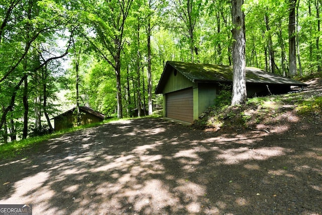 view of home's exterior featuring a garage and an outdoor structure