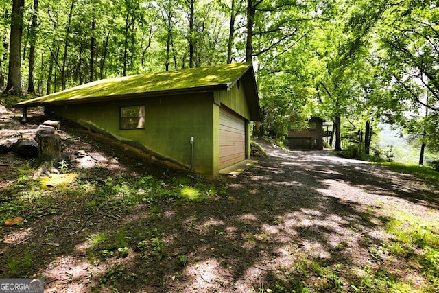 view of home's exterior with an outdoor structure and a garage