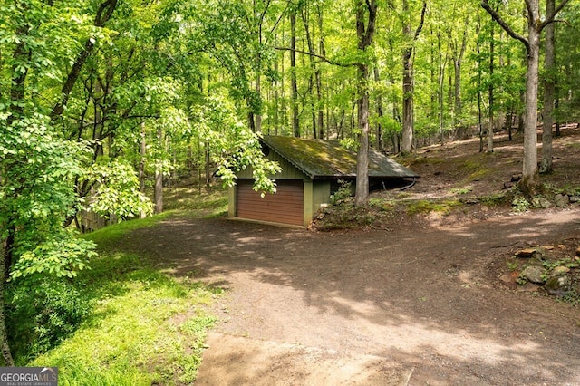 view of yard with a garage and an outdoor structure