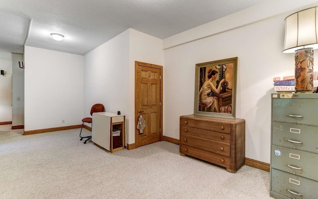 living area with light carpet and a textured ceiling