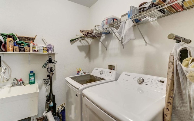 clothes washing area featuring washer and dryer and sink