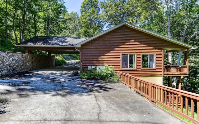 view of side of home with a carport