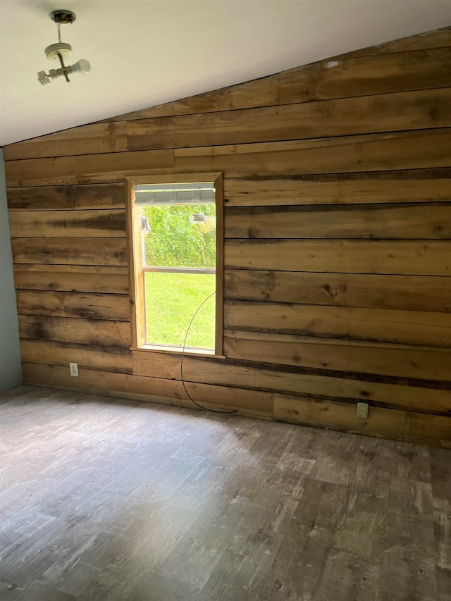 spare room featuring lofted ceiling and dark wood-type flooring