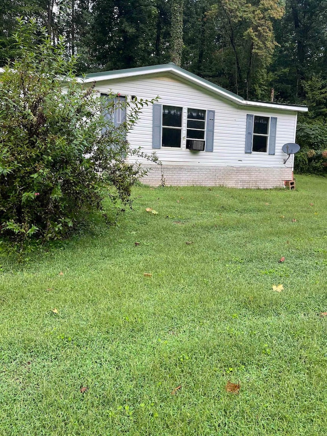 view of side of home featuring a yard