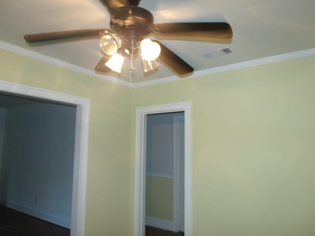 interior details featuring ornamental molding and ceiling fan