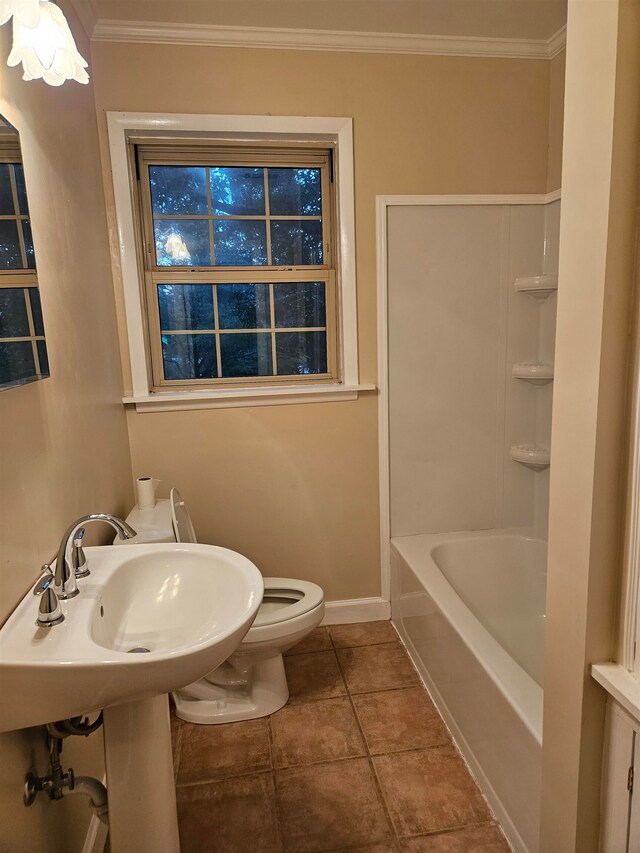 bathroom with toilet, crown molding, and tile patterned floors