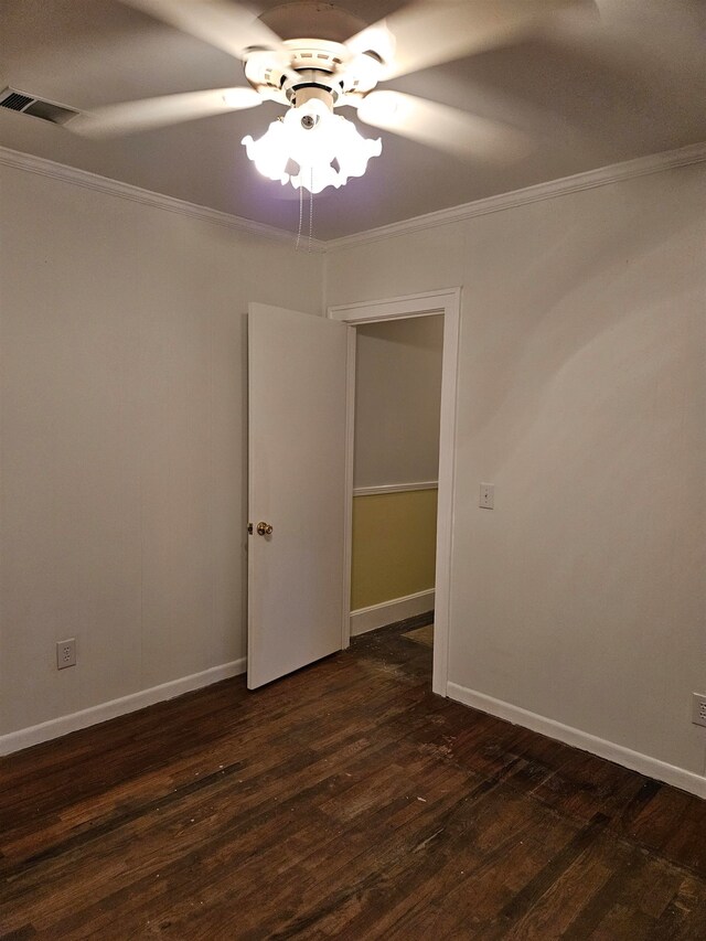 unfurnished room with crown molding, ceiling fan, and dark hardwood / wood-style flooring