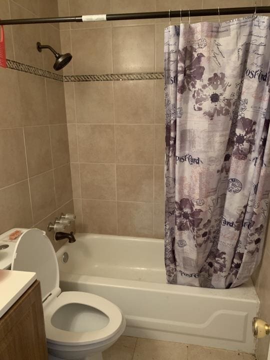 full bathroom with vanity, shower / bath combination with curtain, tile floors, and toilet