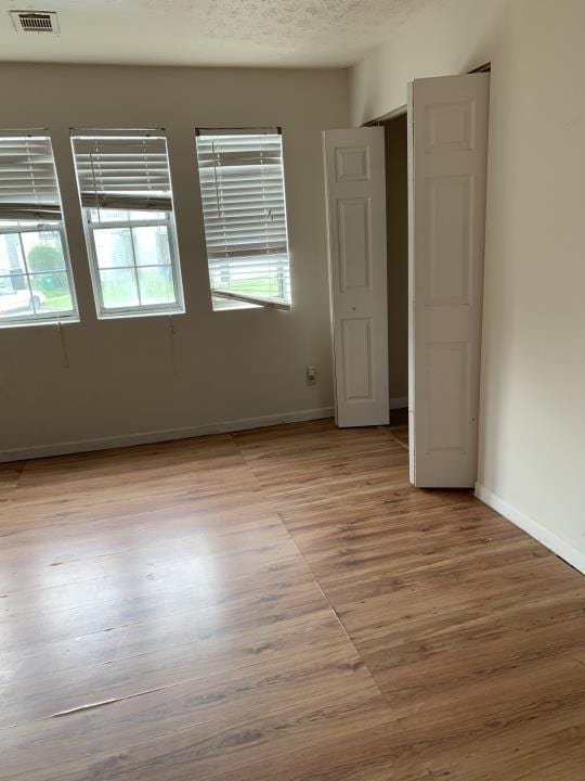 empty room with light hardwood / wood-style flooring