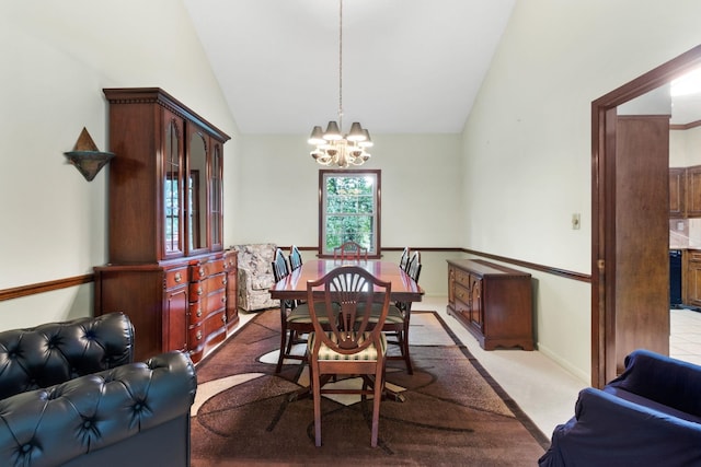 carpeted dining area featuring lofted ceiling and a chandelier