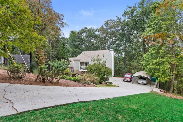 view of front facade with covered porch, a front yard, and a carport