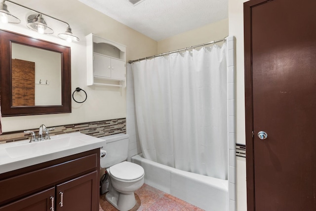 full bathroom with shower / tub combo with curtain, toilet, vanity with extensive cabinet space, a textured ceiling, and tile floors