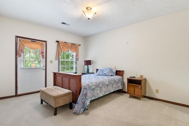 carpeted bedroom with a textured ceiling