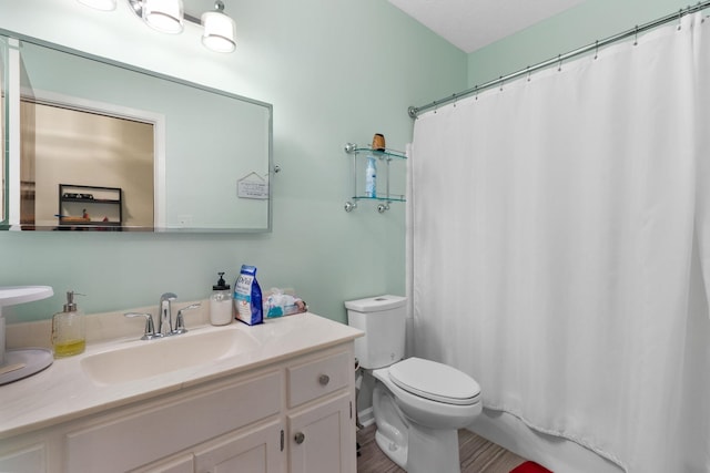 bathroom featuring toilet and vanity with extensive cabinet space