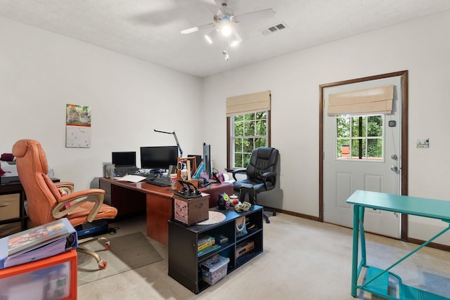 home office featuring plenty of natural light, a textured ceiling, and ceiling fan