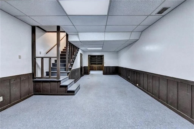 interior space with light carpet and a paneled ceiling