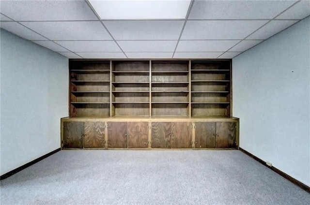 carpeted empty room featuring a paneled ceiling