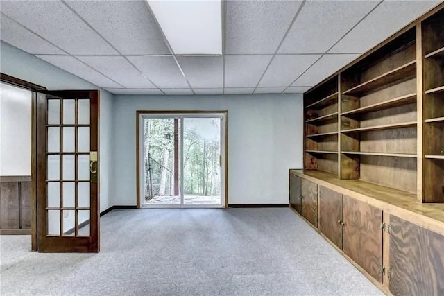 unfurnished room with carpet floors and a paneled ceiling