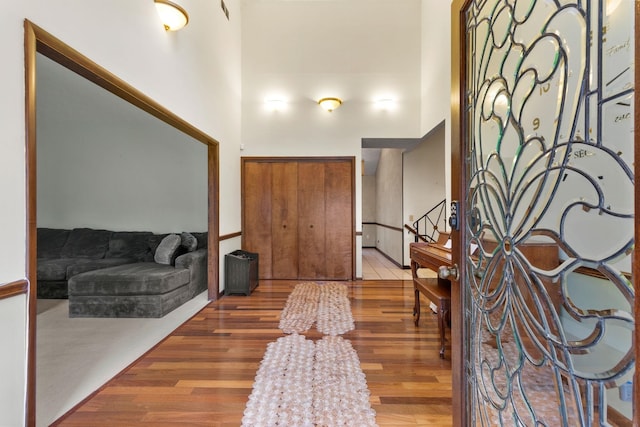 entrance foyer with a high ceiling and dark tile flooring