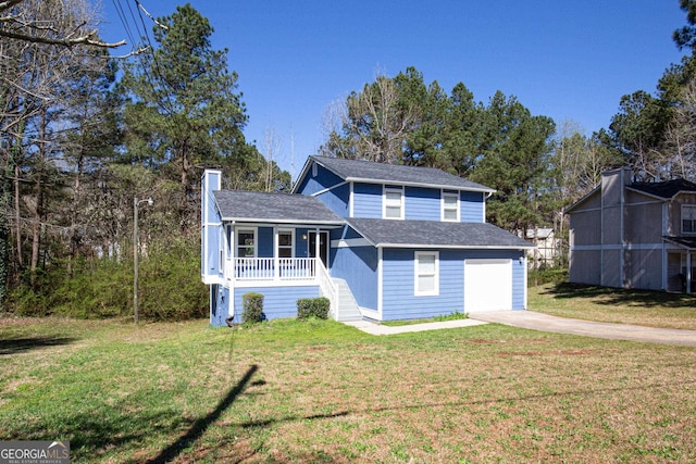 view of front of property with a front lawn, covered porch, and a garage