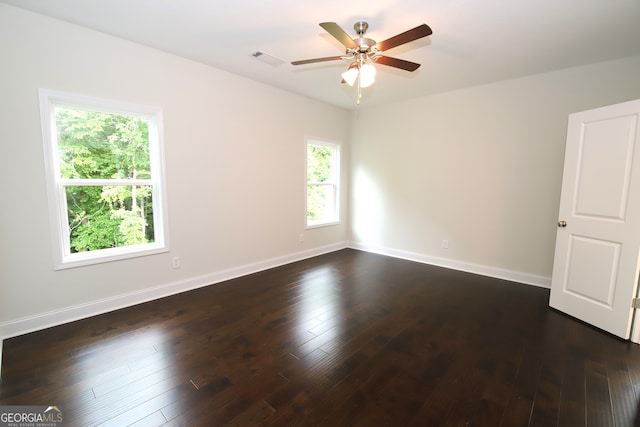 unfurnished room with ceiling fan and dark hardwood / wood-style floors