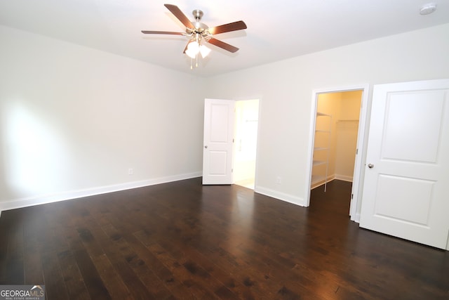 interior space with ceiling fan and dark hardwood / wood-style flooring