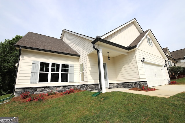 view of front of property with a garage and a front lawn