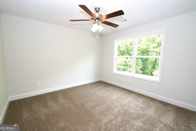 carpeted spare room with ceiling fan