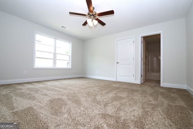 carpeted empty room featuring ceiling fan