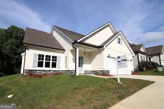 view of front of house with a garage and a front yard