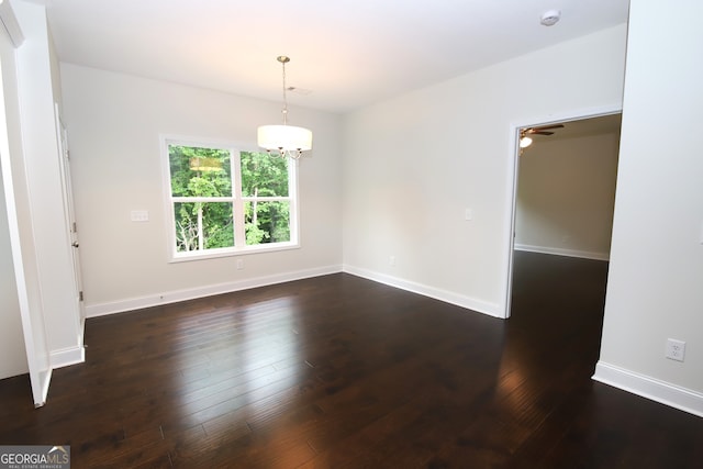 empty room featuring ceiling fan and dark wood-type flooring