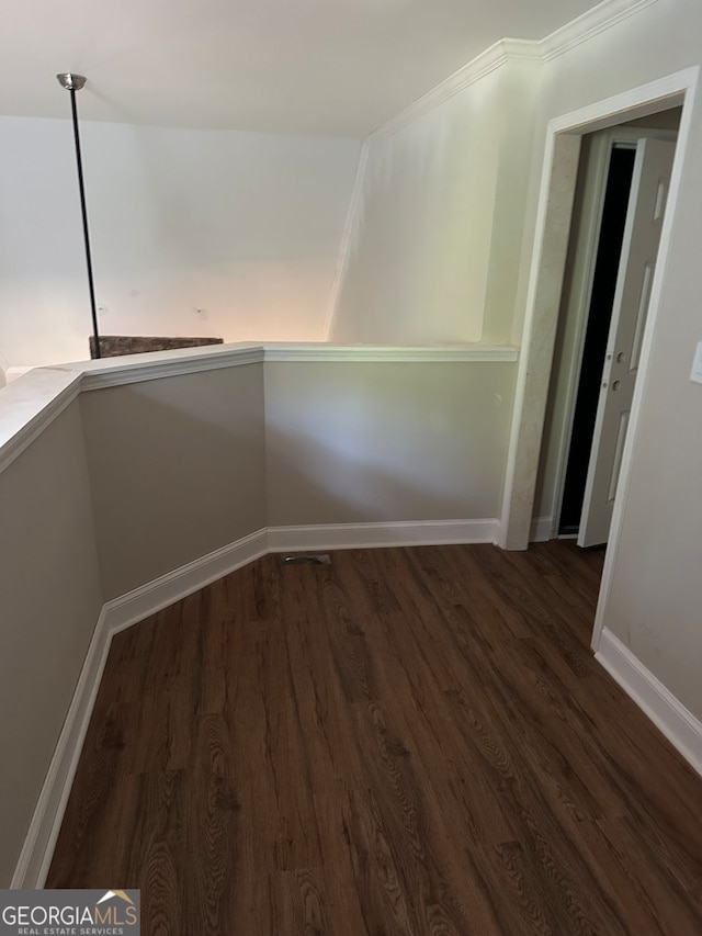 interior space with dark hardwood / wood-style floors and crown molding