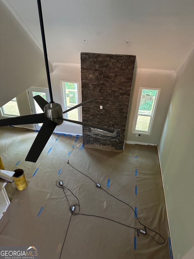 interior space with ceiling fan and ornamental molding