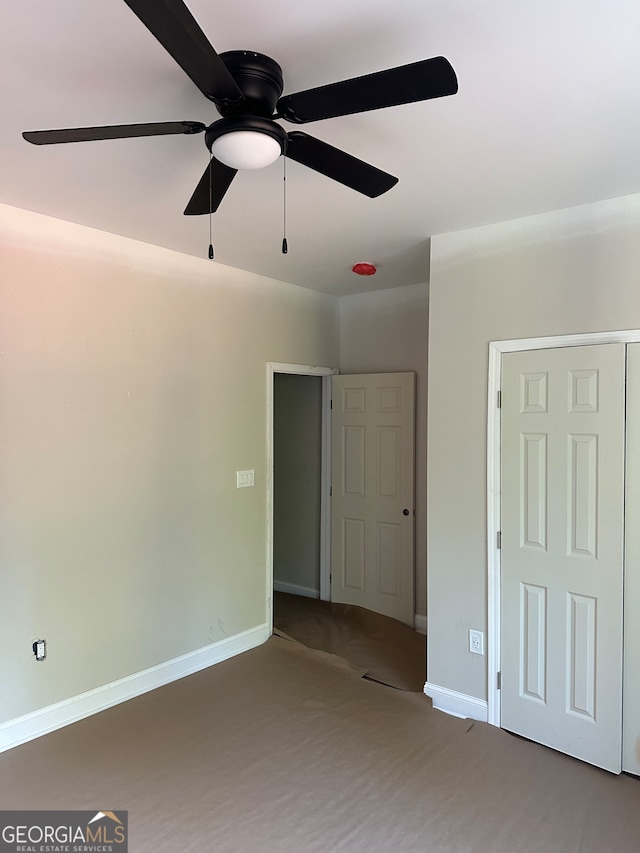 unfurnished bedroom featuring carpet flooring and ceiling fan