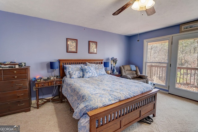 bedroom featuring ceiling fan, light colored carpet, a textured ceiling, and access to outside