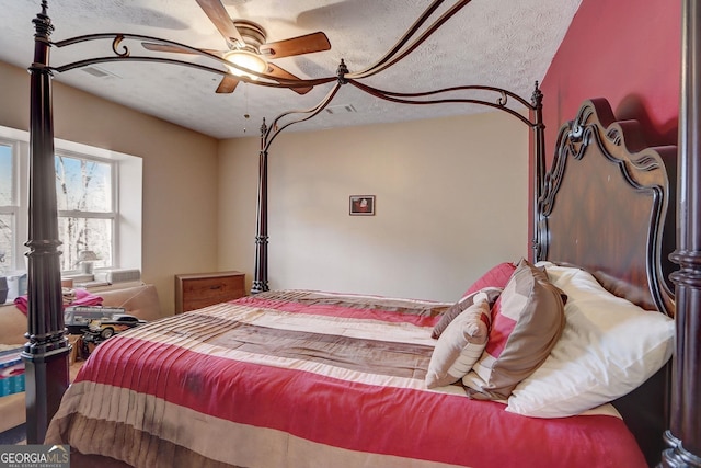 bedroom with a textured ceiling and ceiling fan