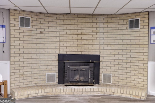 interior details featuring hardwood / wood-style flooring and a drop ceiling