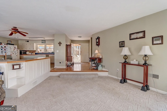 living room with ceiling fan and light carpet