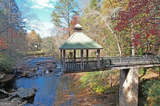 dock area with a water view and a gazebo