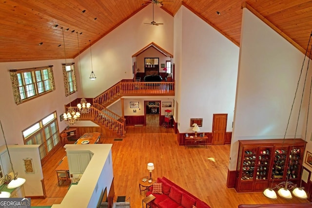 recreation room with hardwood / wood-style flooring, high vaulted ceiling, ceiling fan with notable chandelier, and wooden ceiling