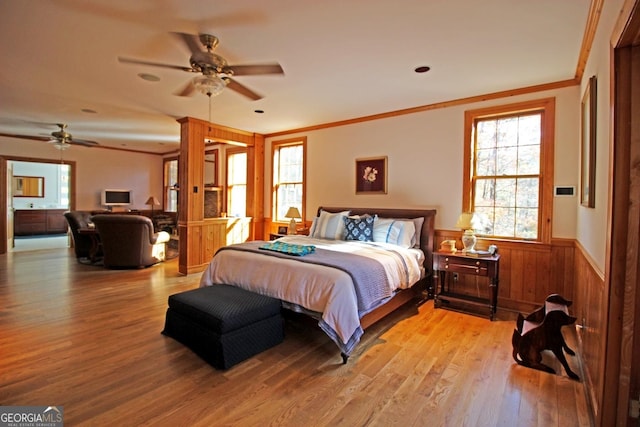 bedroom featuring ceiling fan, light wood-type flooring, and crown molding