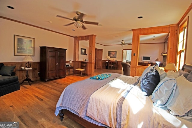 bedroom featuring ceiling fan, crown molding, and dark hardwood / wood-style floors